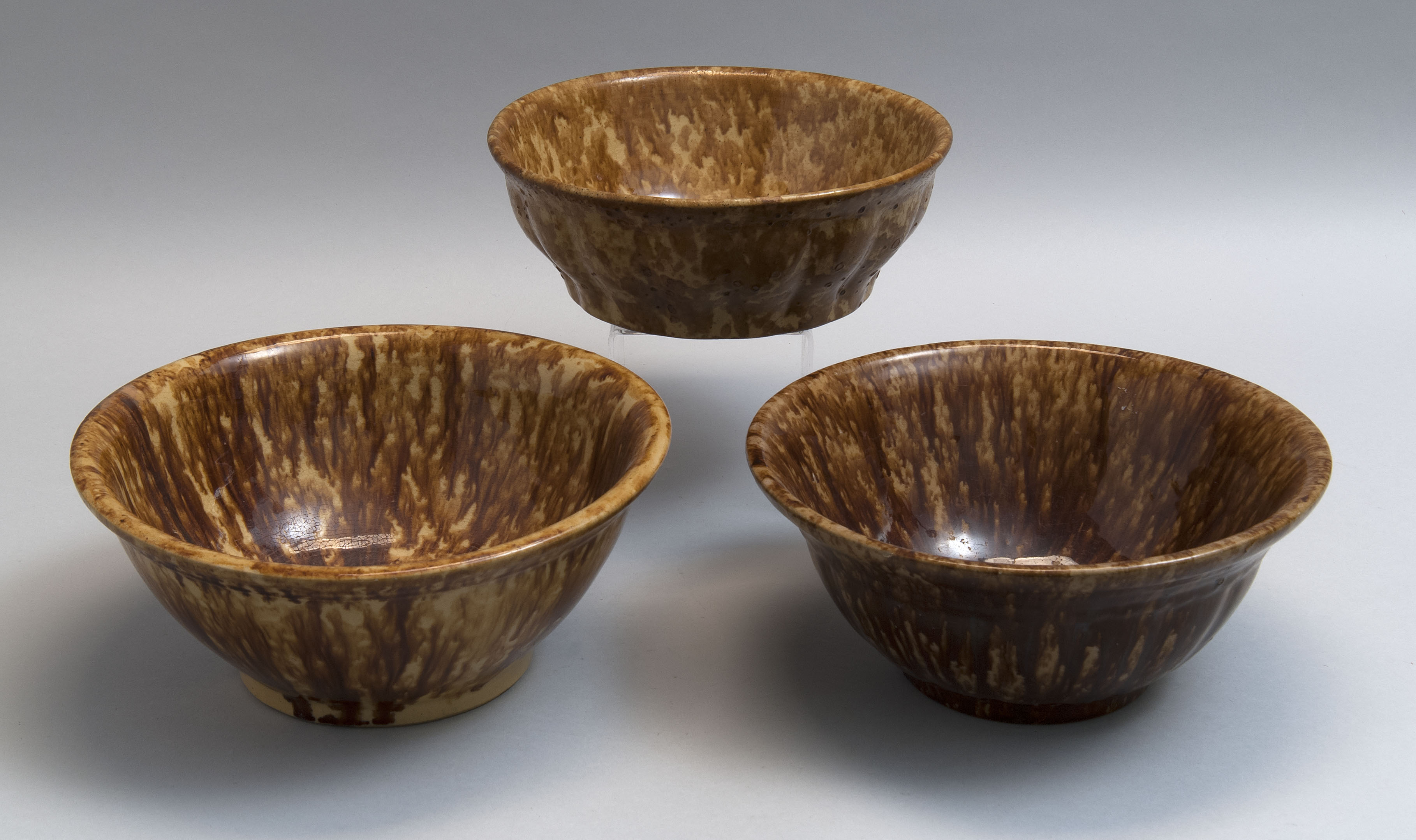 Appraisal: THREE NESTING ROCKINGHAM GLAZE MIXING BOWLS Late th CenturyTwo with