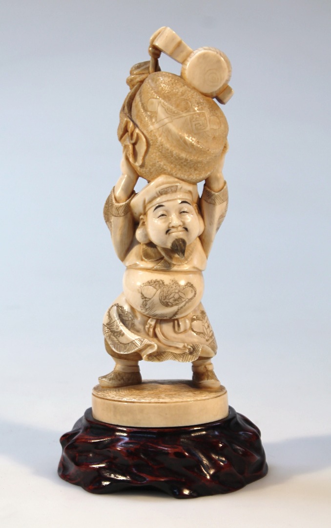 Appraisal: A thC Japanese ivory figure of a pot bellied gentleman