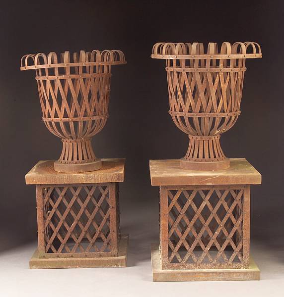 Appraisal: A pair of Neoclassical style iron latticework urns on pedestals