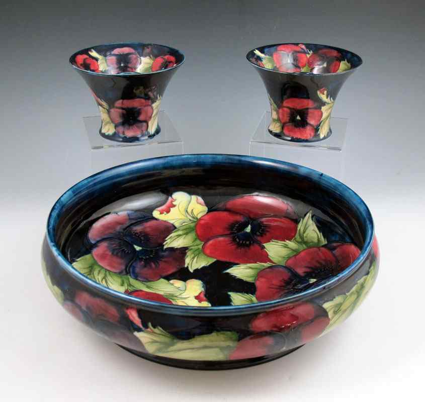 Appraisal: MOORCROFT PANSY CENTERBOWL CANDLESTICKS To include Centerbowl with incised and