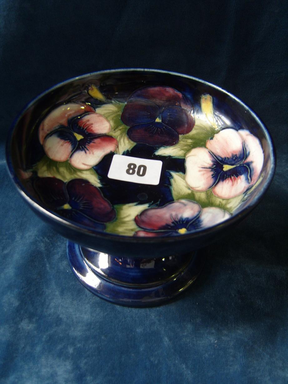 Appraisal: A blue ground Moorcroft comport of circular form with moulded