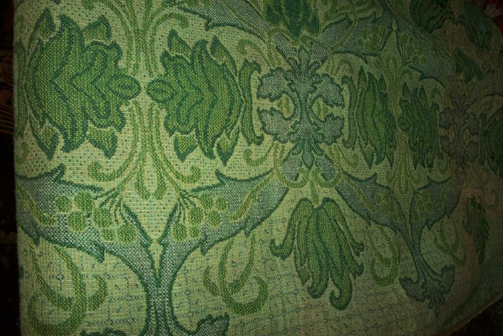 Appraisal: A green ground woven panel in the Kelmscot manner with