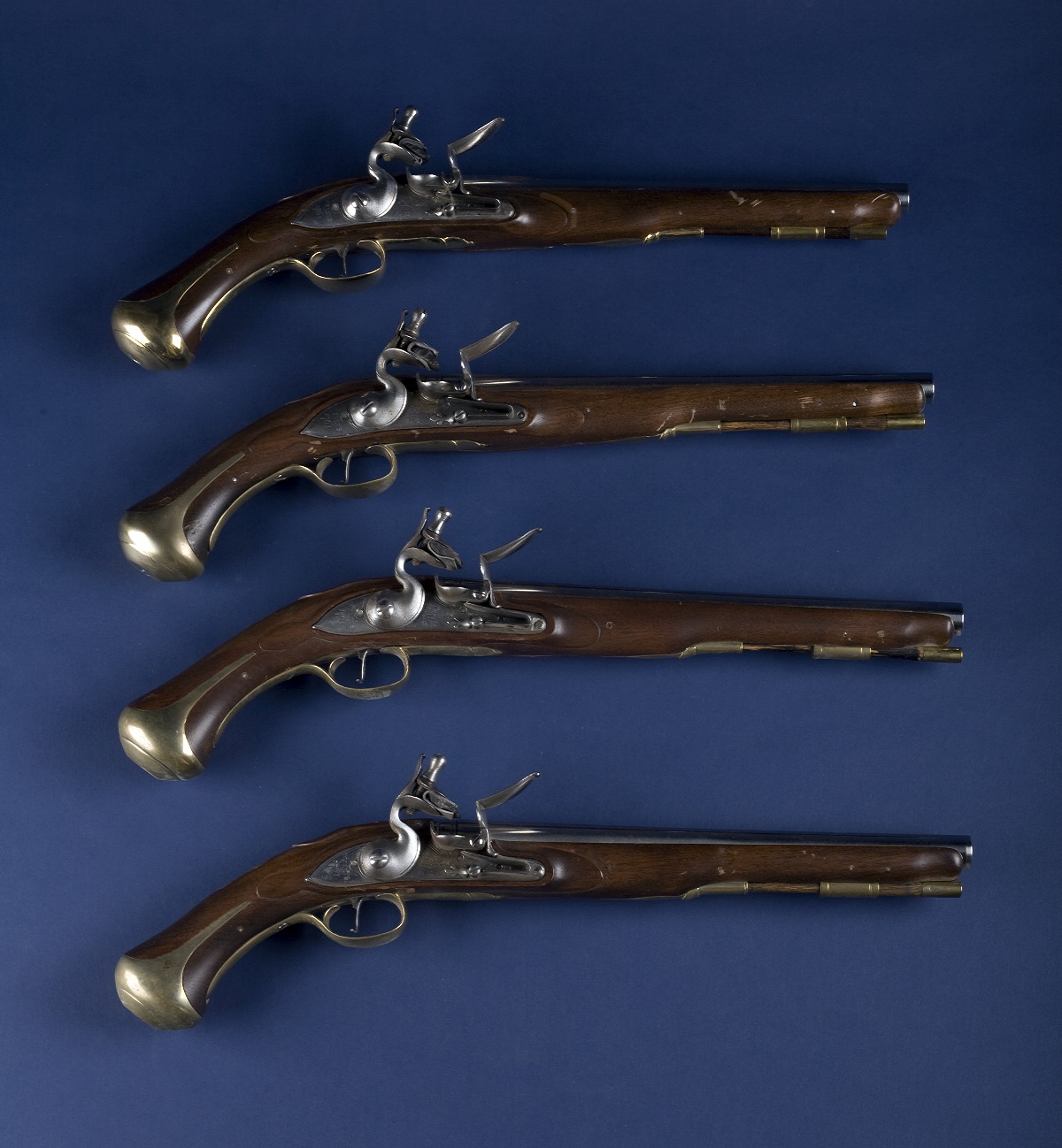 Appraisal: FOUR REPRODUCTION FLINTLOCK PISTOLS MADE FOR COLONIAL WILLIAMSBURG Each with