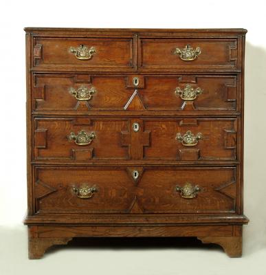 Appraisal: AN OAK CHEST with moulded edged top two short over