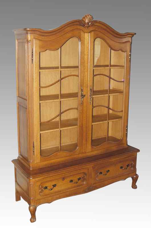 Appraisal: COUNTRY FRENCH OAK CHINA CABINET BOOKCASE Carved crest over glass