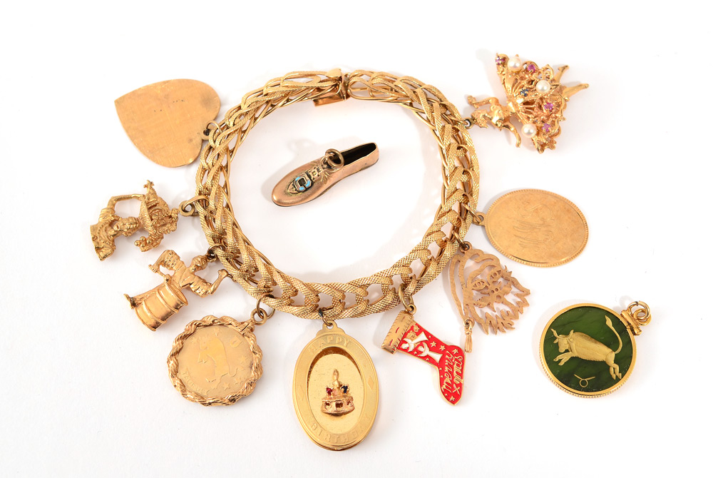 Appraisal: k YELLOW GOLD CHARM BRACELET AND CHARMS inch multi link