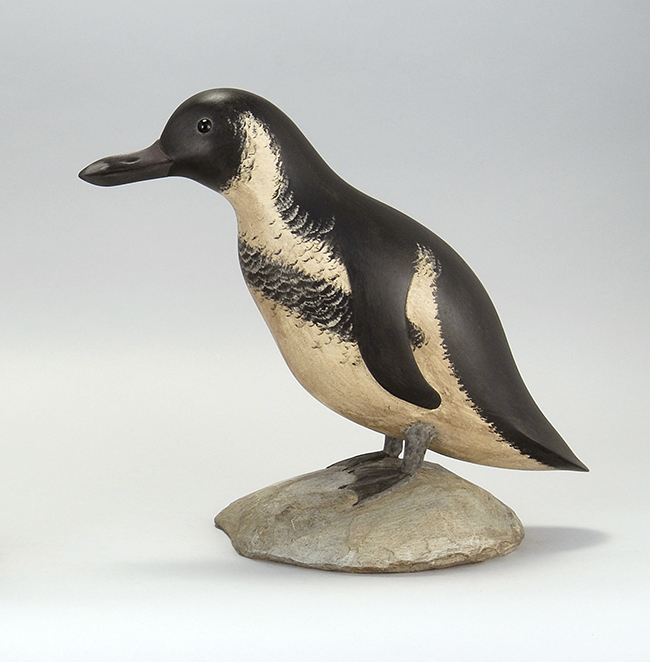 Appraisal: LIFE-SIZE CARVING OF A BLACK-FOOTED PENGUIN By Daniel Bruffee of