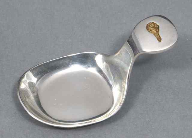 Appraisal: A MILLENNIUM SILVER CADDY SPOON with a heavy 'Frying Pan'