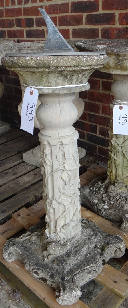 Appraisal: A reconstituted stone sundial on fluted column relief moulded with