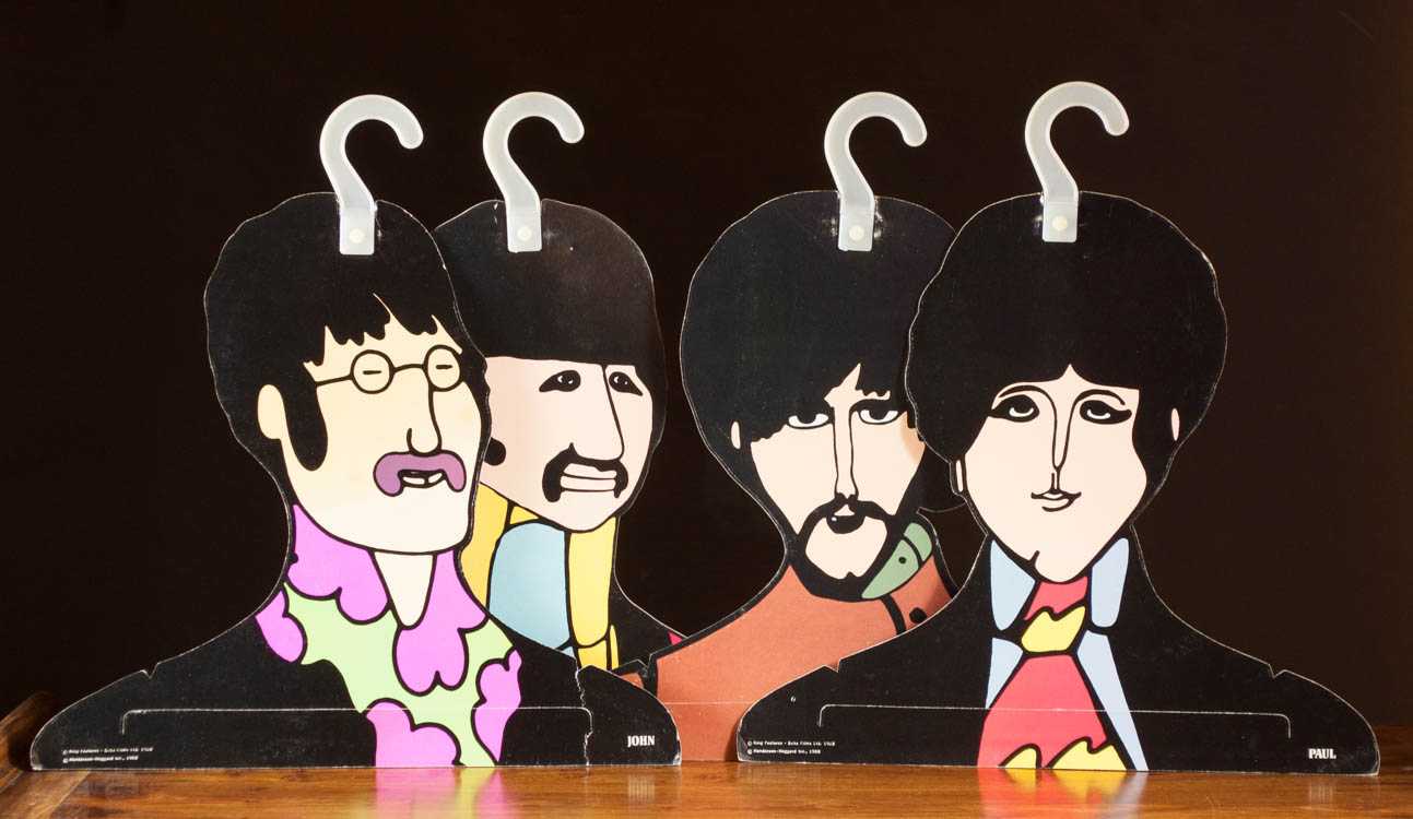 Appraisal: SET OF FOUR BEATLES YELLOW SUBMARINE HANGERS double sided picture