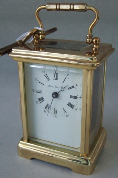 Appraisal: A gilt brass cased carriage clock the white enamel dial