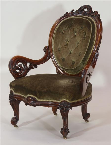 Appraisal: A Victorian mahogany armchair the oval button back with foliate