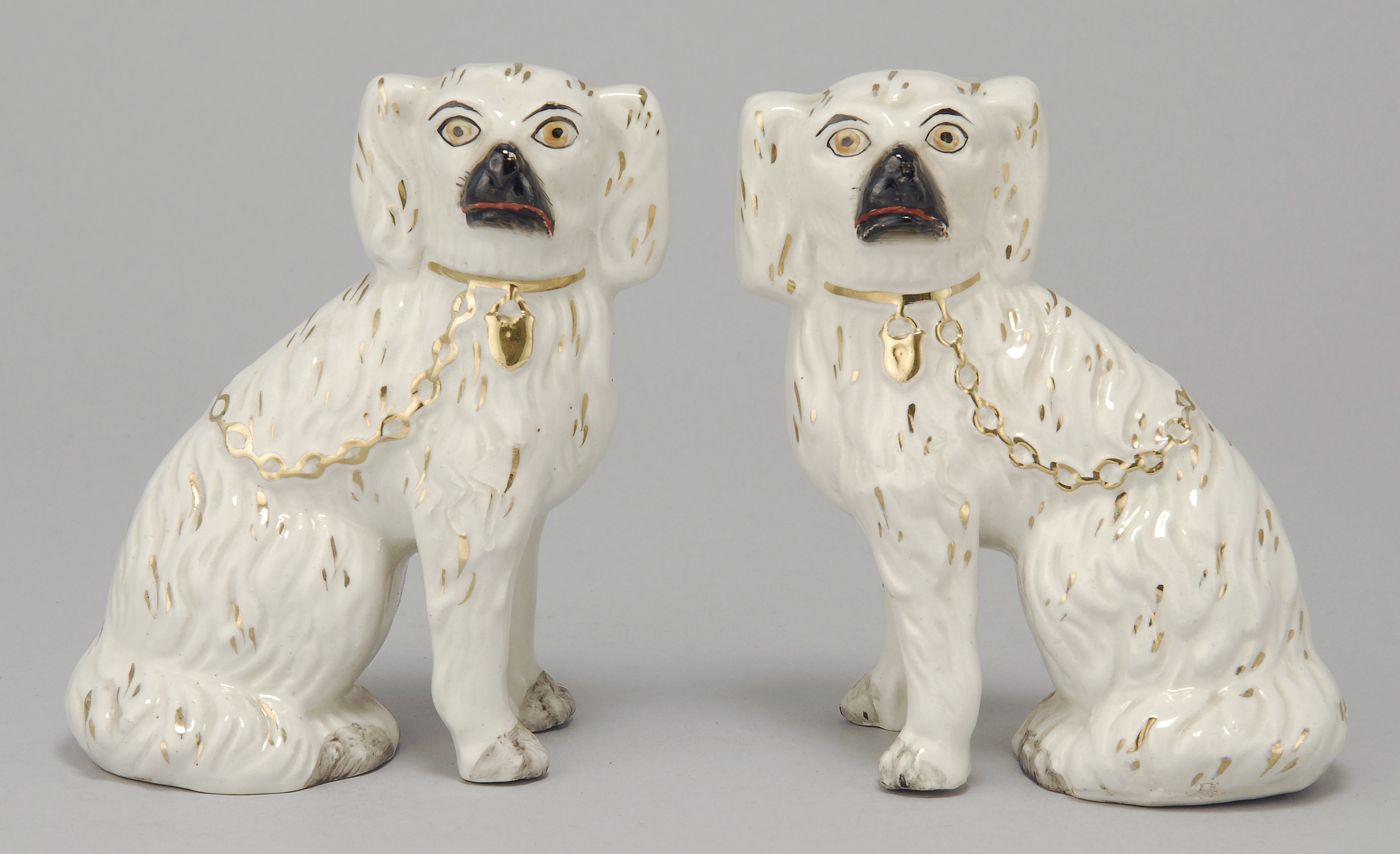 Appraisal: PAIR OF STAFFORDSHIRE SPANIELS th CenturyWith gilt and black highlights