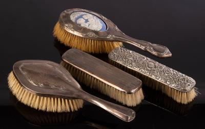 Appraisal: A silver mounted dressing brush with a porcelain back and