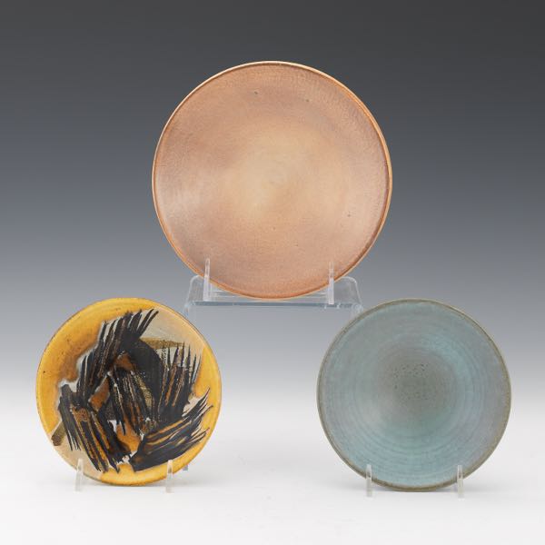 Appraisal: THREE MADOURA POTTERY STUDIO DISHES One with ochre and black