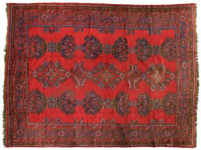 Appraisal: Oushak rug repeating geometric medallions on bright brick red field