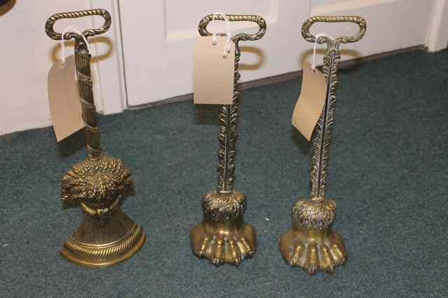 Appraisal: A TH CENTURY PAIR OF BRASS DOORSTOPS with lion's paw