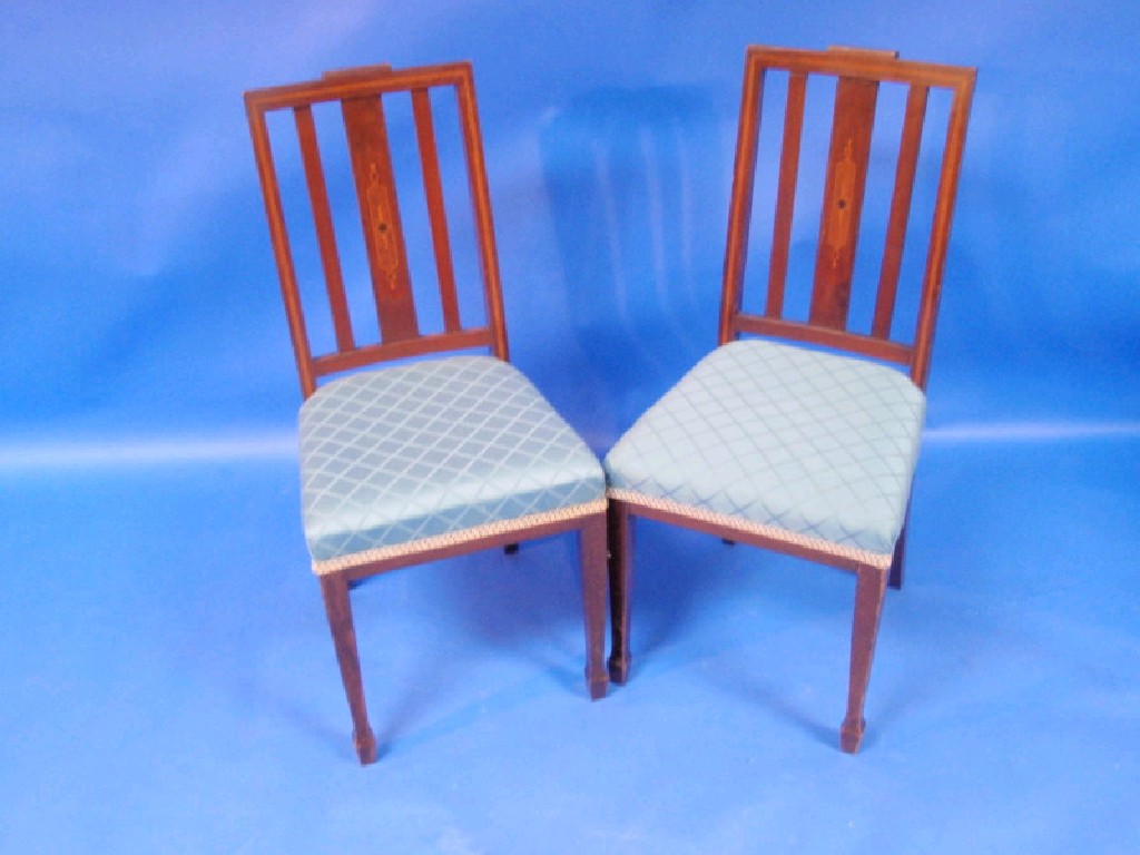 Appraisal: A pair of Edwardian inlaid mahogany single chairs with high