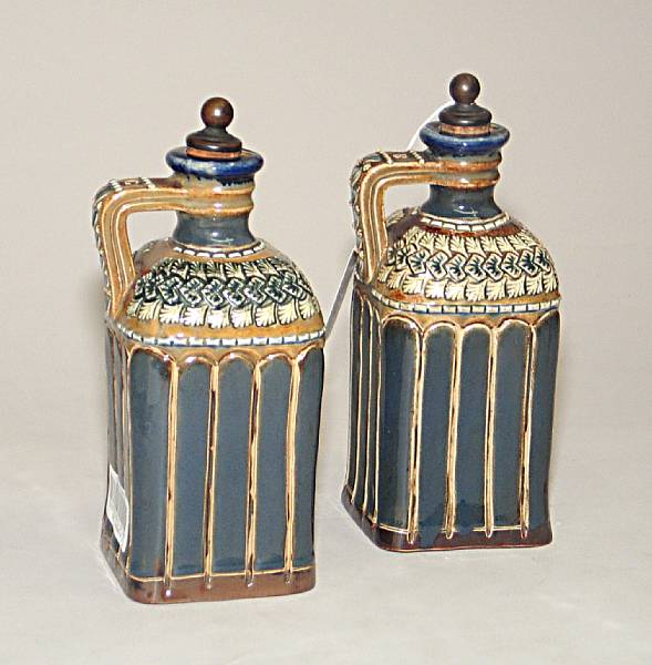 Appraisal: A pair of Doulton Lambeth salt glazed stoneware decanter jugs