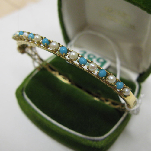 Appraisal: PEARL TURQUOISE AND FOURTEEN KARAT GOLD BANGLE The oval shaped