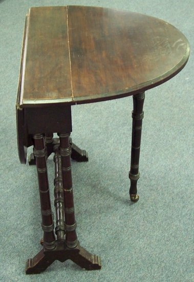 Appraisal: A th Century oval two-flap table on turned end standards