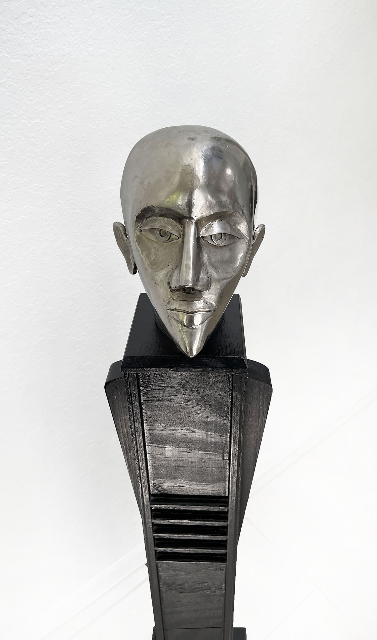 Appraisal: STUART PETERMAN ''THE HEAD'' STAINLESS SCULPTURE Mounted on an ebonized