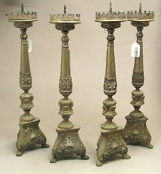 Appraisal: A set of four Baroque style brass repouss altar prickets