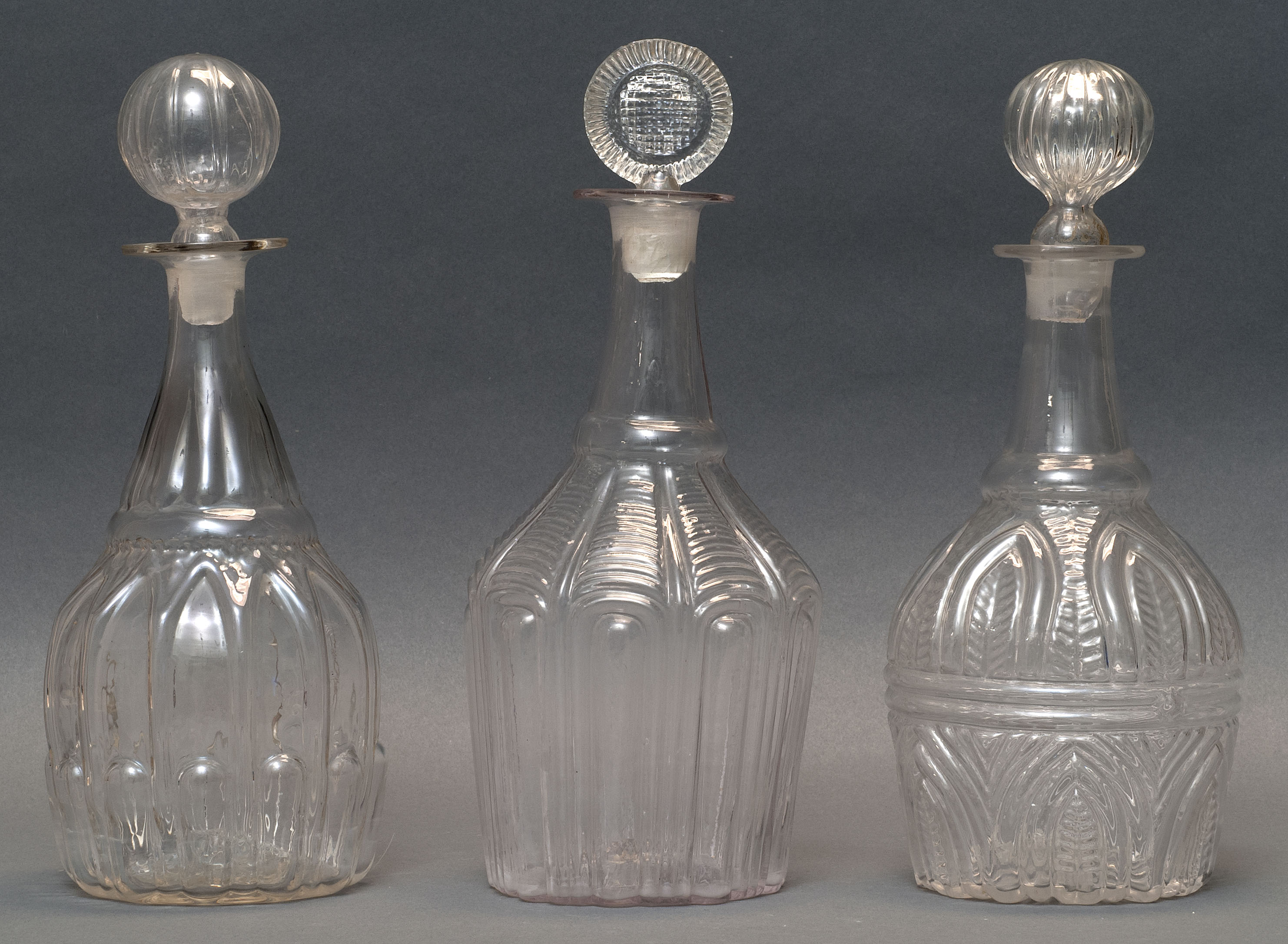 Appraisal: THREE CLEAR GLASS BLOWN -MOLD DECANTERS Second Quarter of the