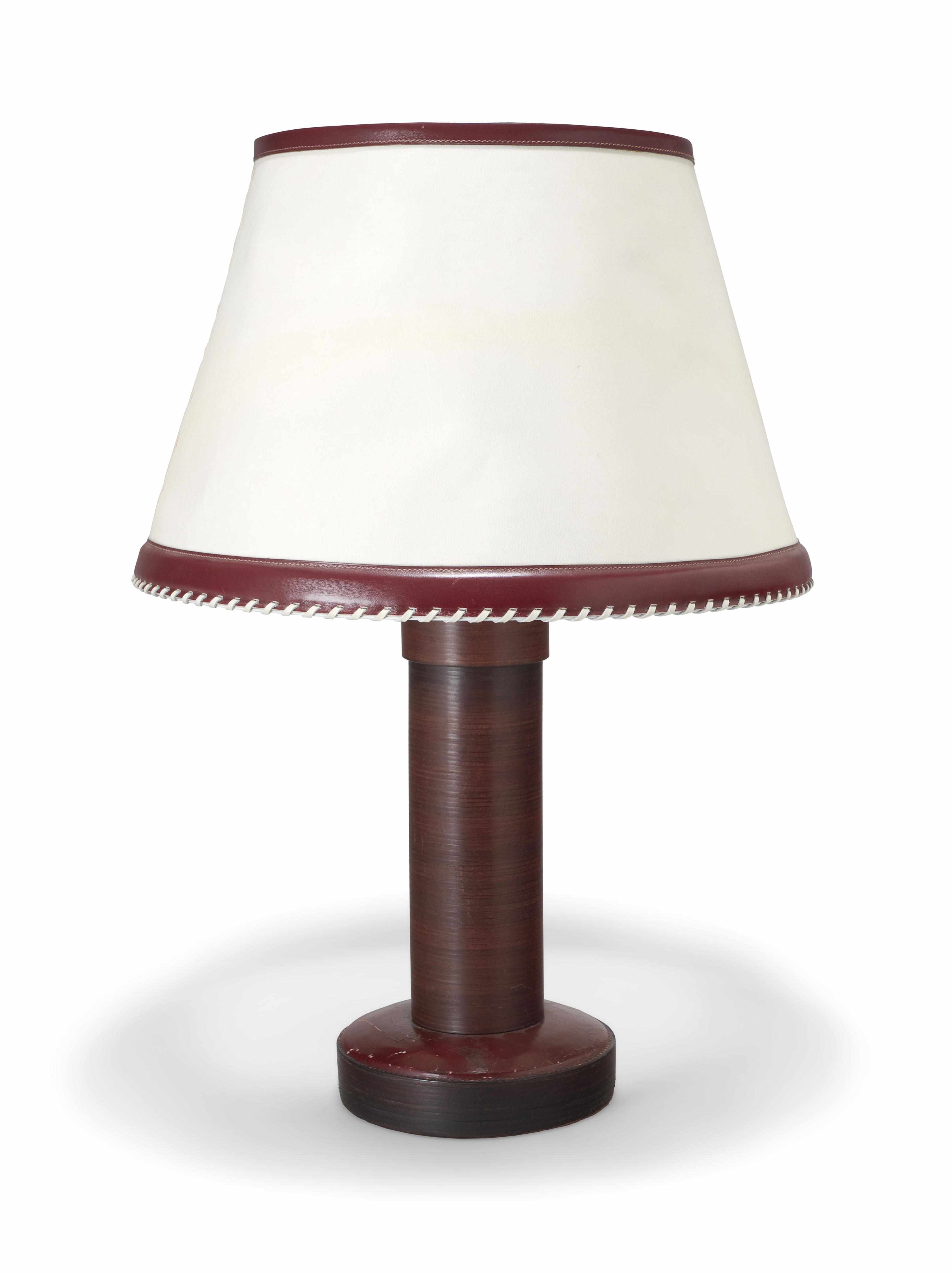 Appraisal: A Paul Dupr-Lafon leather and stacked wood table lamp s