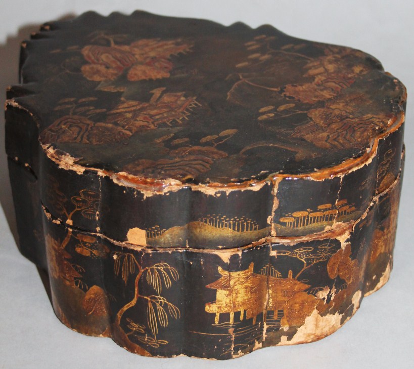 Appraisal: A thC Chinese black lacquer supper box set the leaf