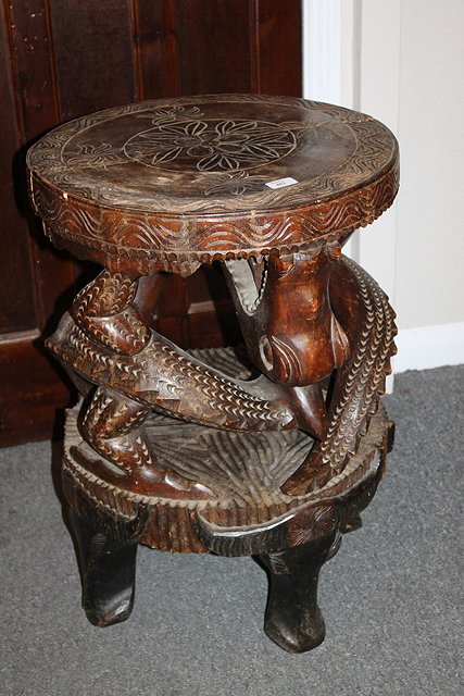 Appraisal: AN AFRICAN CARVED STAND with dragon design having a circular