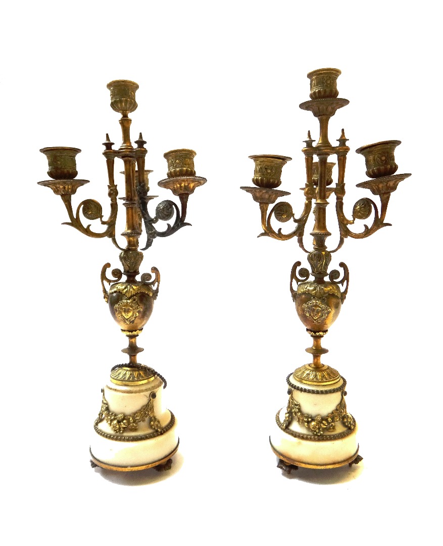 Appraisal: A pair of brass and marble mounted four branch candelabra