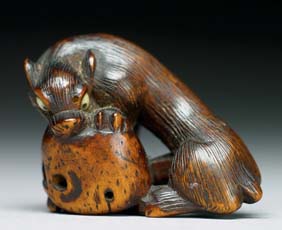 Appraisal: ANTIQUE WOOD NETSUKE Carved and antique wood netsuke of a