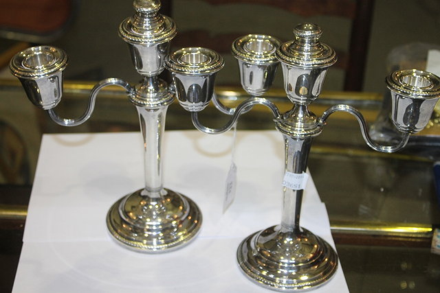 Appraisal: A PAIR OF SILVER TWO BRANCH CANDELABRA on pedestal feet