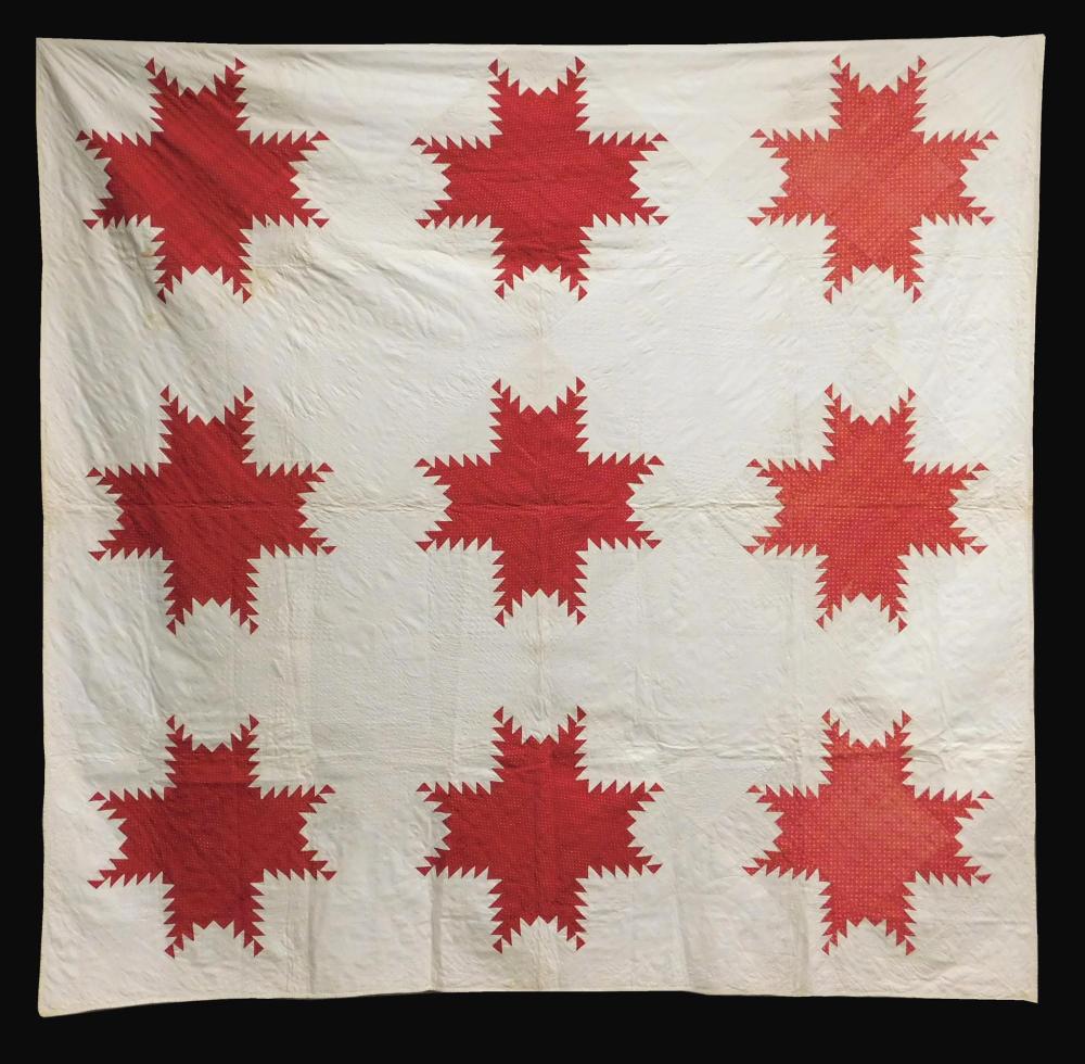 Appraisal: TEXTILE Pieced quilt with nine large feathered stars in red