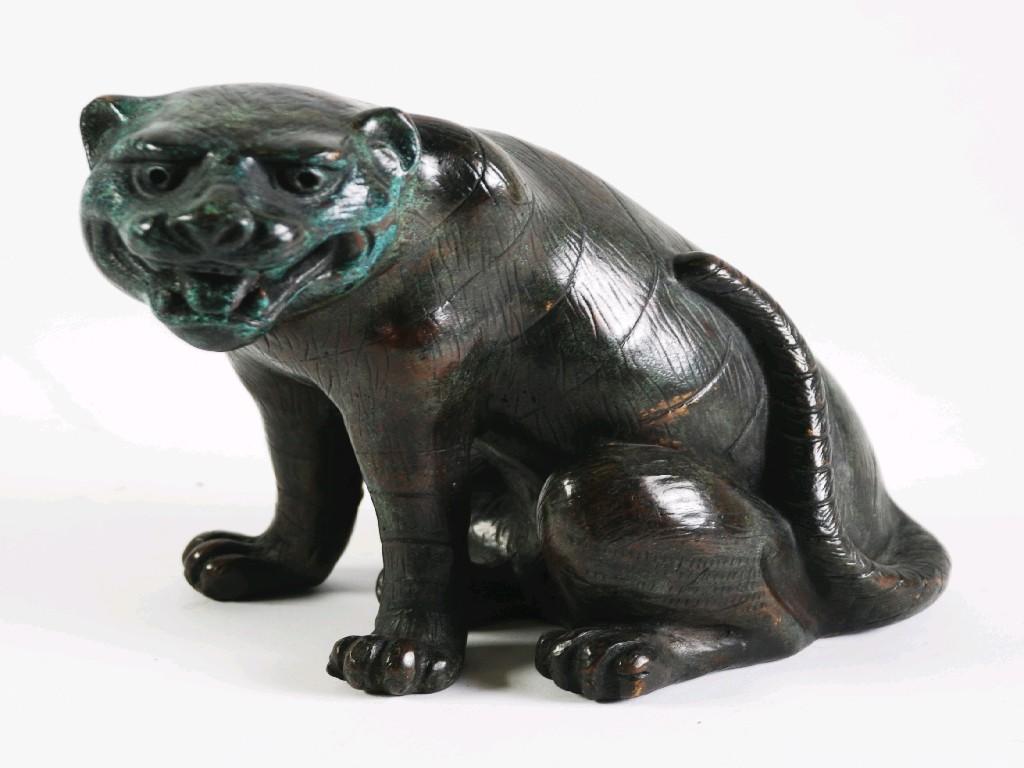 Appraisal: ORIENTAL PATINATED BRONZE MODEL OF A SEATED TIGER cm high