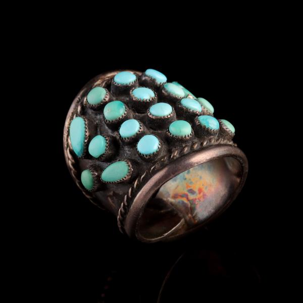 Appraisal: A STERLING SILVER RING WITH PERSIAN TURQUOISEThe petit point settings