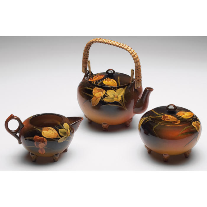 Appraisal: Rookwood tea set teapot with wicker handle creamer and sugar