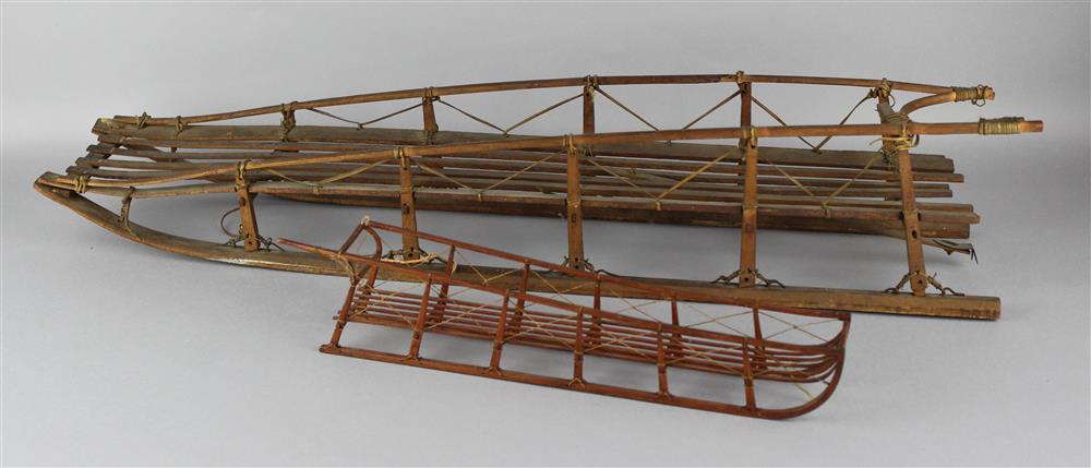 Appraisal: TWO ESKIMO INUIT WOODEN SLED MODELS bentwood and sinew bound