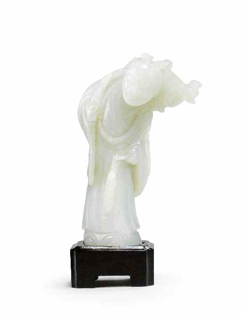 Appraisal: A Chinese celadon jade carving of a man modelled standing