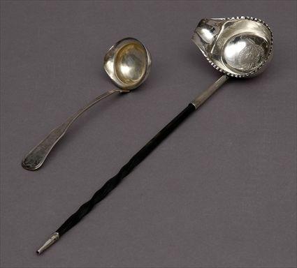 Appraisal: ENGLISH EBONY-HANDLED SILVER TODDY LADLE AND A DANISH SAUCE LADLE