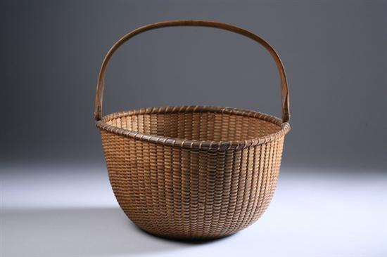 Appraisal: LARGE NANTUCKET SWING HANDLE BASKET late th- early th century