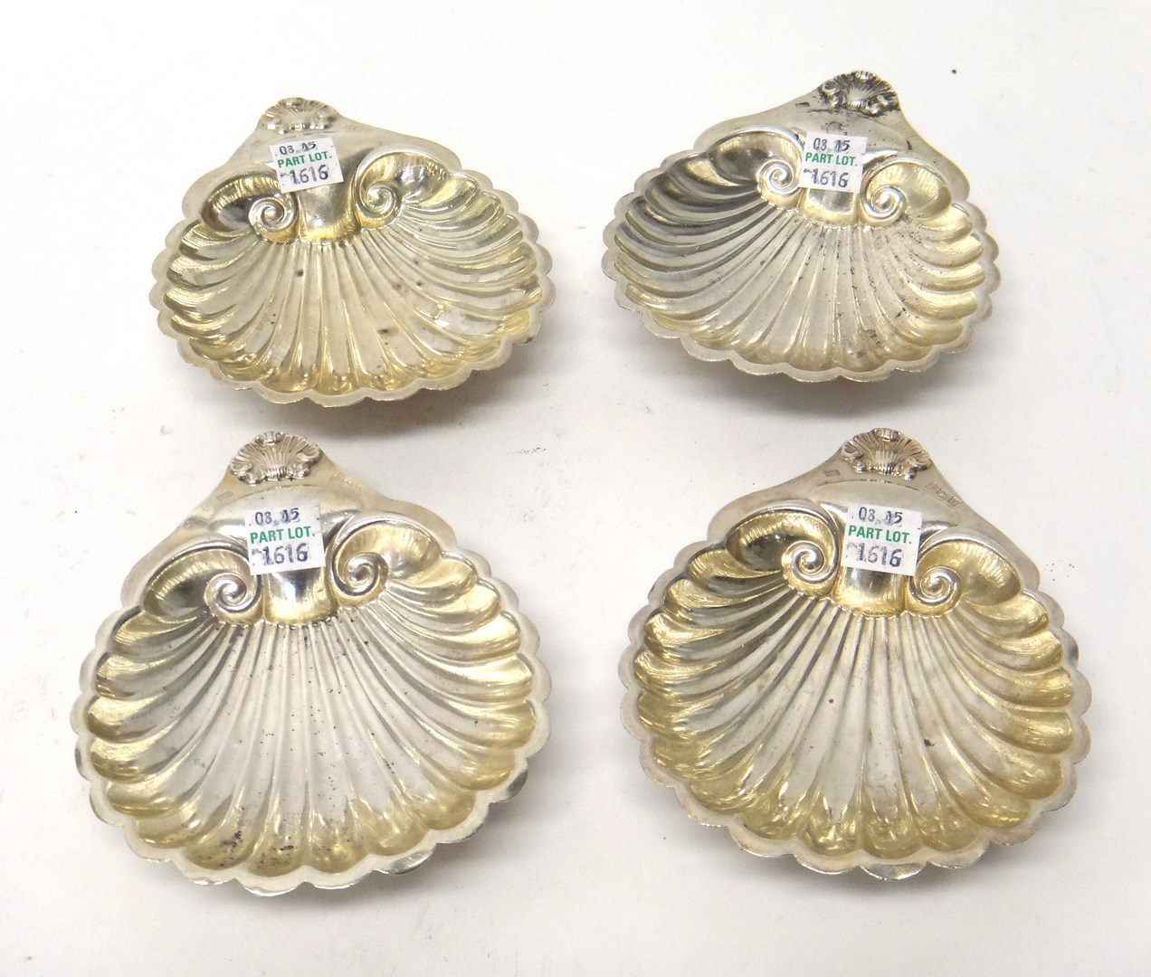 Appraisal: A set of four silver butter shells each raised on