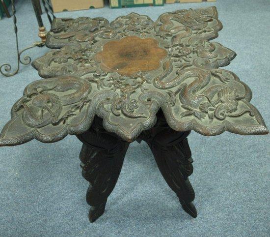 Appraisal: A heavily carved table with dragon design throughout cm wide