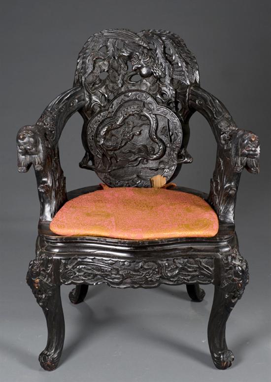 Appraisal: Highly carved Chinese teak and lacquer open armchair Late th