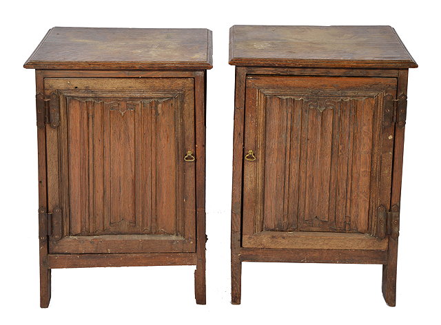 Appraisal: A PAIR OF OAK BEDSIDE CABINETS with panelled sides and