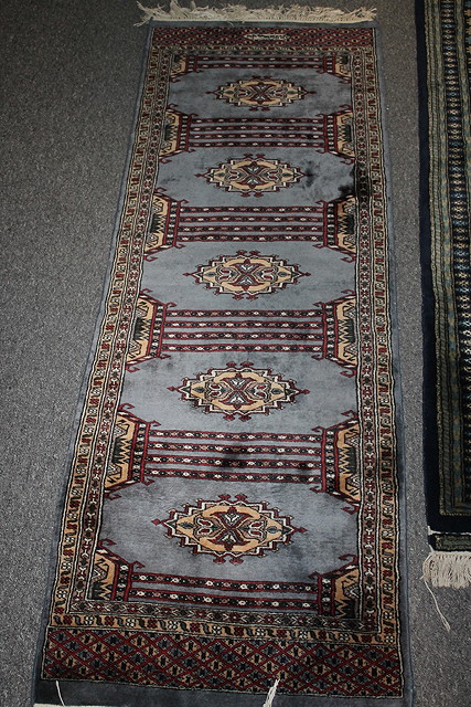 Appraisal: AN AFGHAN PALE BLUE GROUND RUG with five medallions and