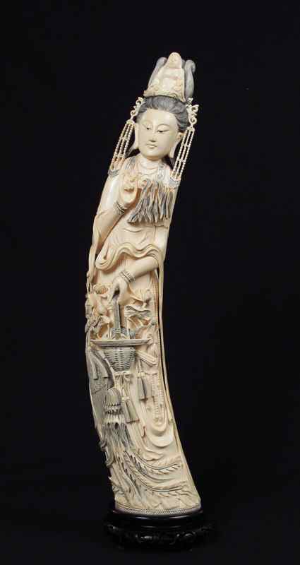 Appraisal: MONUMENTAL FIGURAL CARVED IVORY WOMAN Headdress is figural seated Buddha