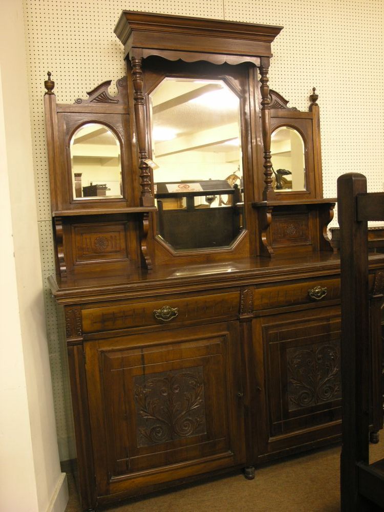 Appraisal: An Edwardian walnut tall sideboard mirrored back with turned columns