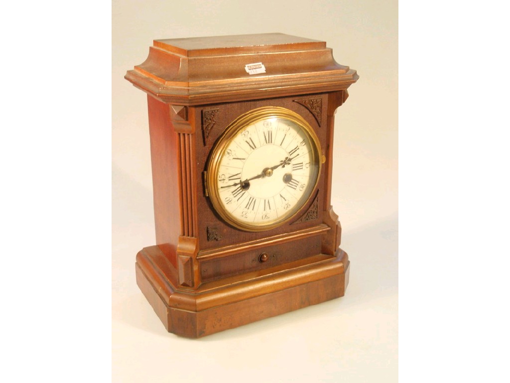 Appraisal: A walnut cased mantel clock with German eight-day movement striking